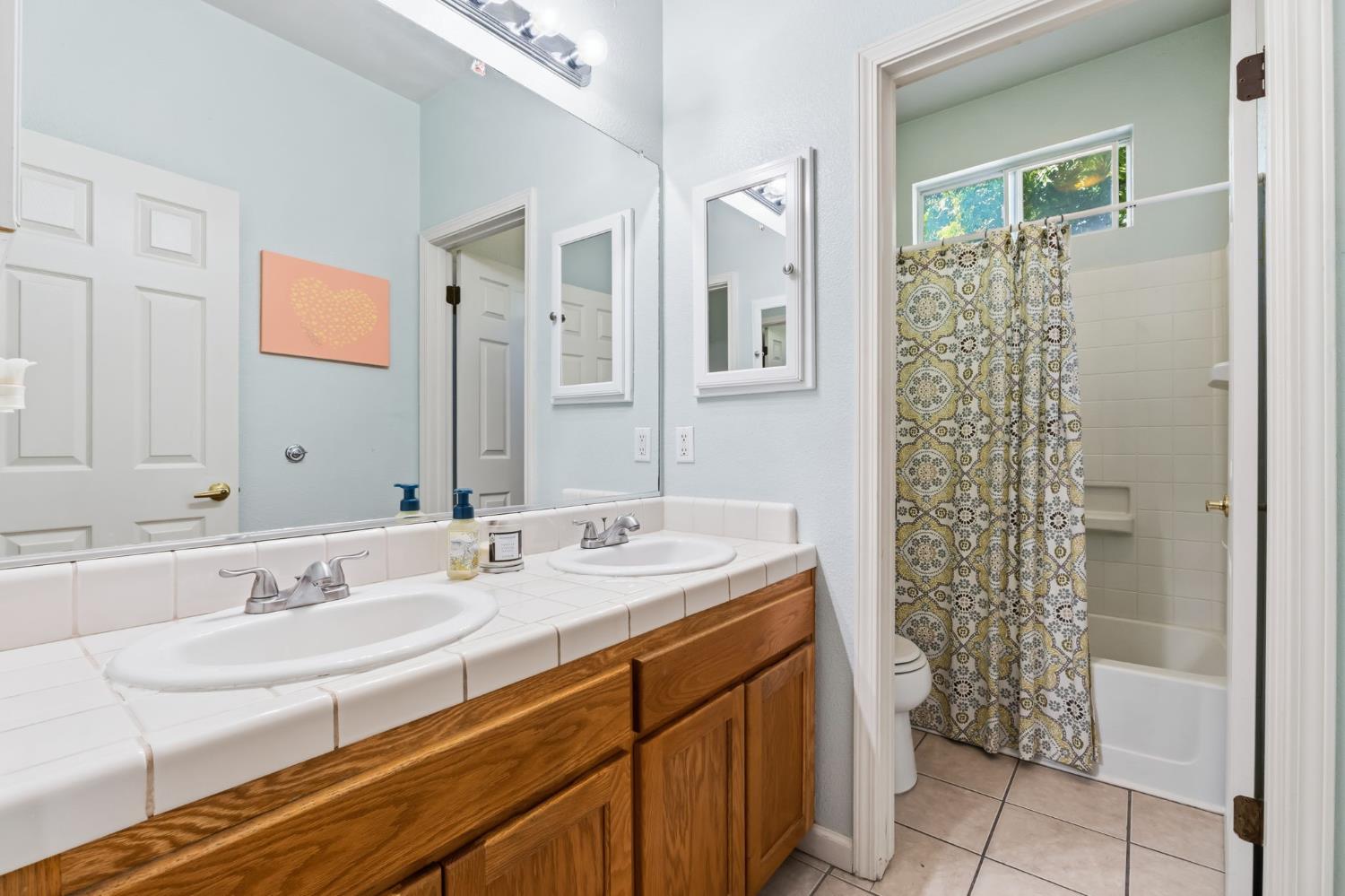 1757 Homestead Way Lemoore, CA 93245 - Photo 23 of 35 a bathroom with a sink a toilet and shower