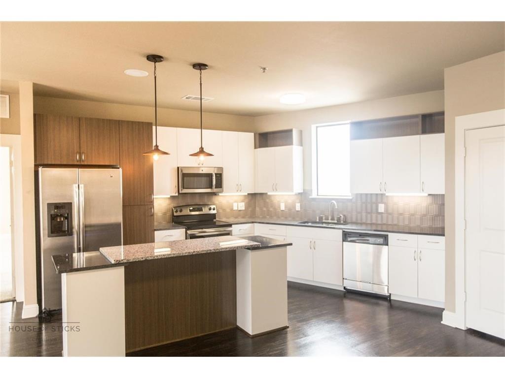 1965 Matilda Street, Unit 214 Dallas, TX 75206 - Photo 2 of 6 a kitchen with stainless steel appliances a sink a stove a refrigerator and cabinets