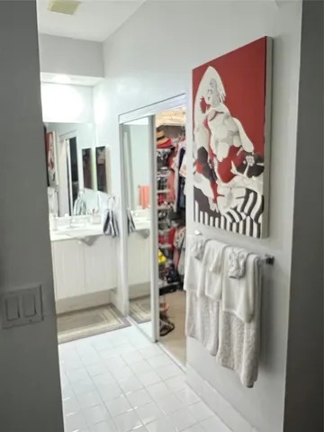 a living room with furniture a chandelier and a dining table