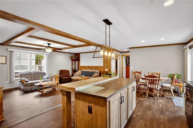 a kitchen with sink refrigerator and large windows