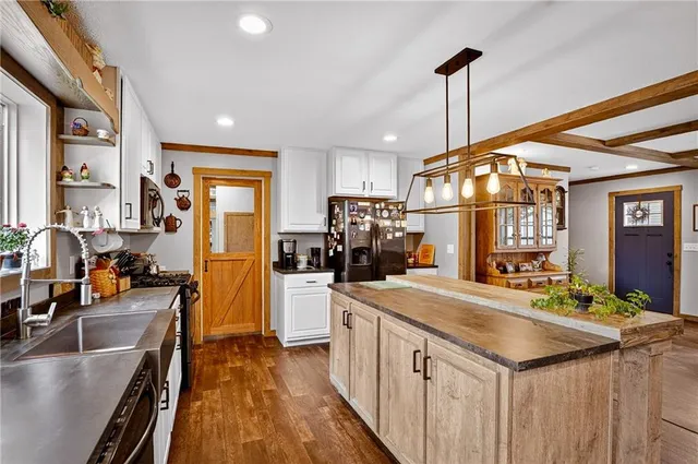 a kitchen with stainless steel appliances a sink stove and cabinets