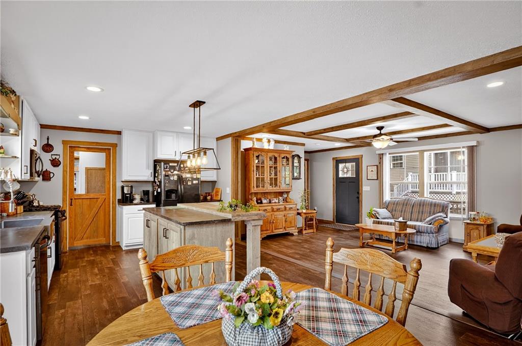 426 Perry Circle Cranberry Township, PA 16066 - Photo 15 of 35 a living room with furniture a fireplace and a dining table with wooden floor