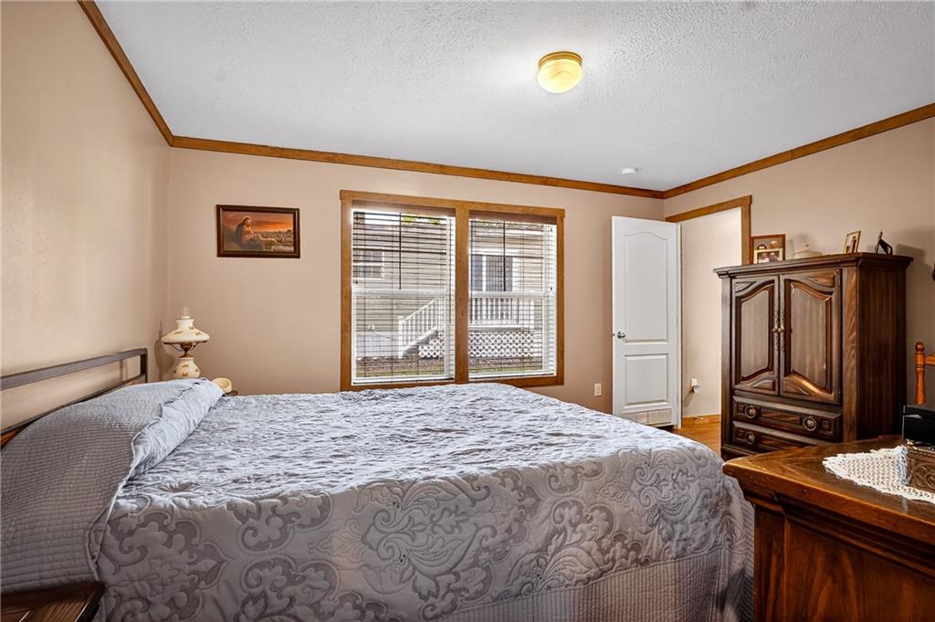 426 Perry Circle Cranberry Township, PA 16066 - Photo 19 of 35 a bedroom with a bed and a flat screen tv