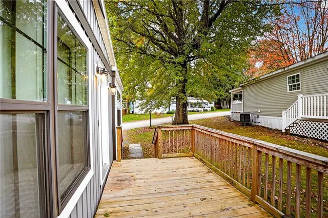 a view of a balcony with wooden floor and outdoor seating