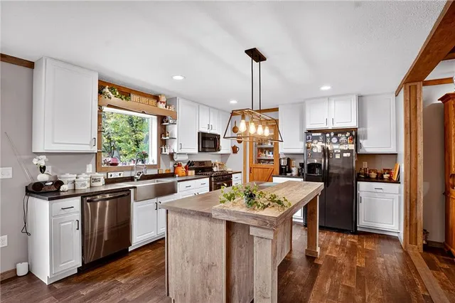 a kitchen with sink a stove and chairs
