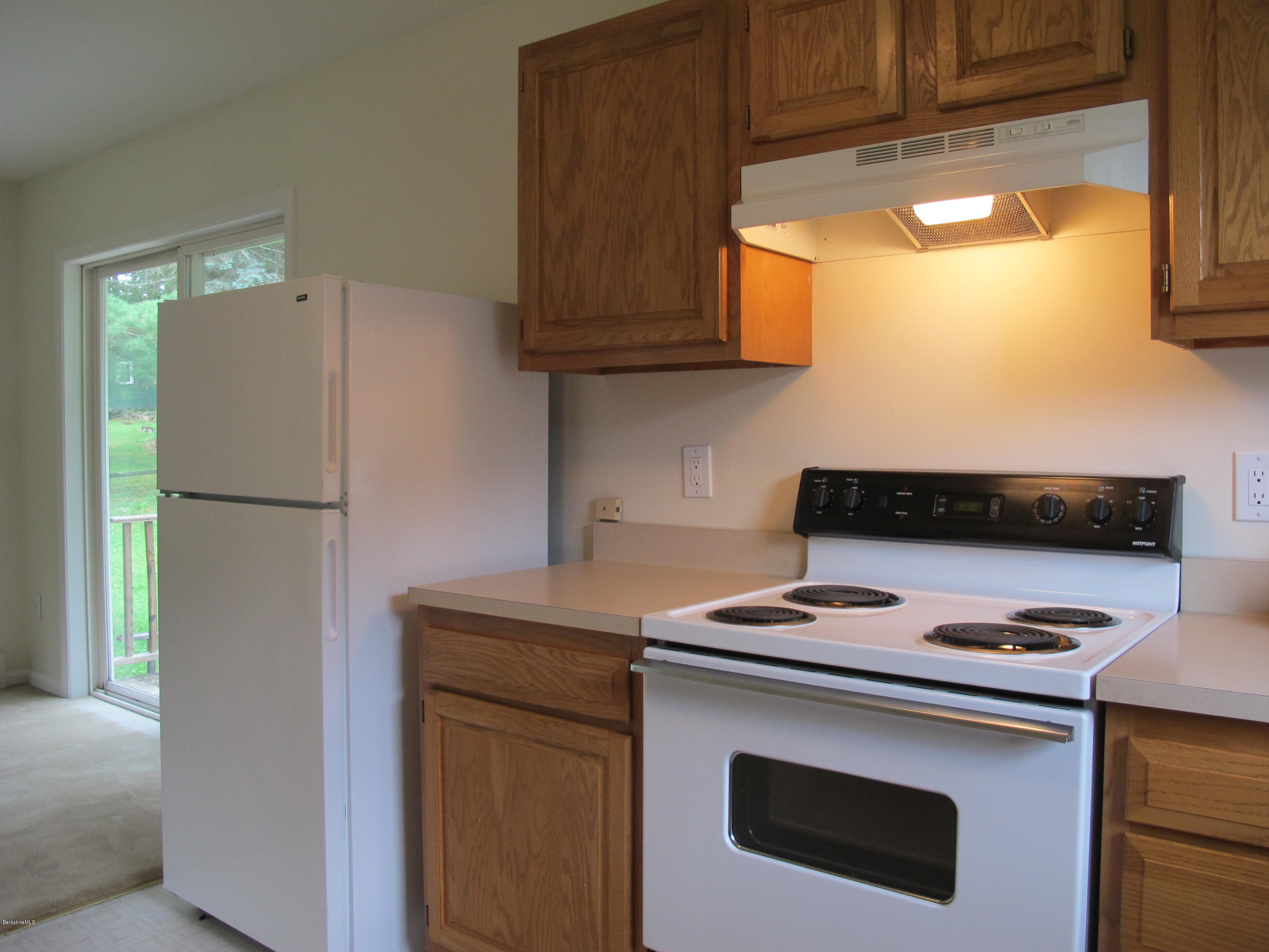 54 Salisbury Road Sheffield, MA 01257 - Photo 10 of 27 a kitchen with stainless steel appliances granite countertop a stove a refrigerator and a microwave