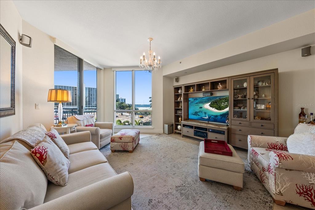 331 Cleveland Street, Unit 301 Clearwater, FL 33755 - Photo 12 of 39 a living room with furniture and a flat screen tv
