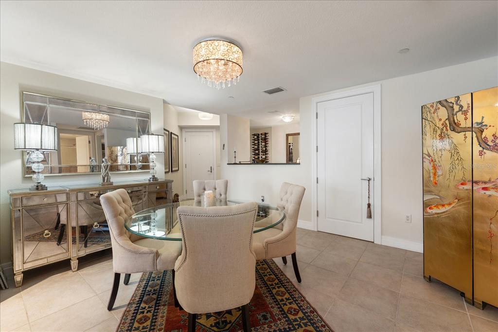 331 Cleveland Street, Unit 301 Clearwater, FL 33755 - Photo 15 of 39 a view of a dining room with furniture and a chandelier