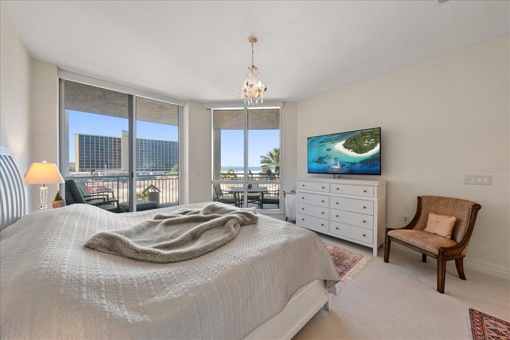 331 Cleveland Street, Unit 301 Clearwater, FL 33755 - Photo 17 of 39 a bedroom with a bed and a flat screen tv