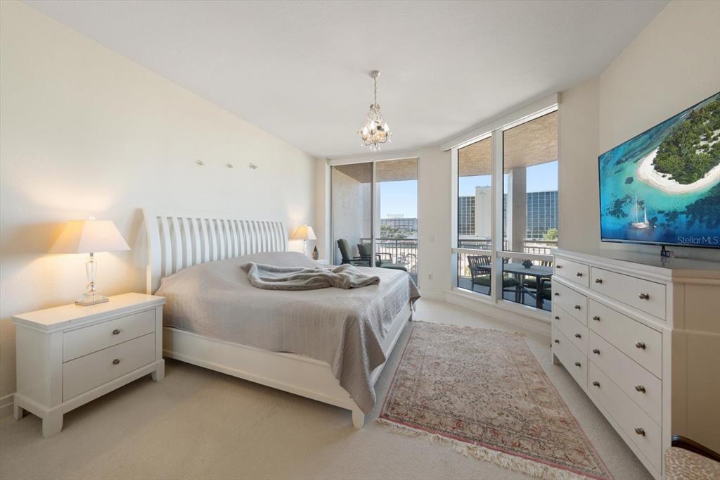 331 Cleveland Street, Unit 301 Clearwater, FL 33755 - Photo 19 of 39 a large bedroom with a bed and a window
