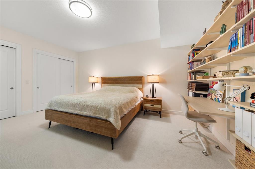 331 Cleveland Street, Unit 301 Clearwater, FL 33755 - Photo 23 of 39 a bedroom with a bed and a chandelier