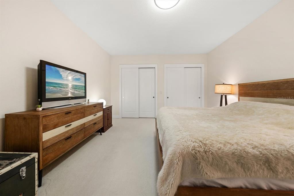331 Cleveland Street, Unit 301 Clearwater, FL 33755 - Photo 24 of 39 a bedroom with a bed and flat screen tv