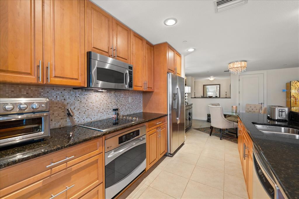 331 Cleveland Street, Unit 301 Clearwater, FL 33755 - Photo 9 of 39 a kitchen with stainless steel appliances a stove a sink and a microwave