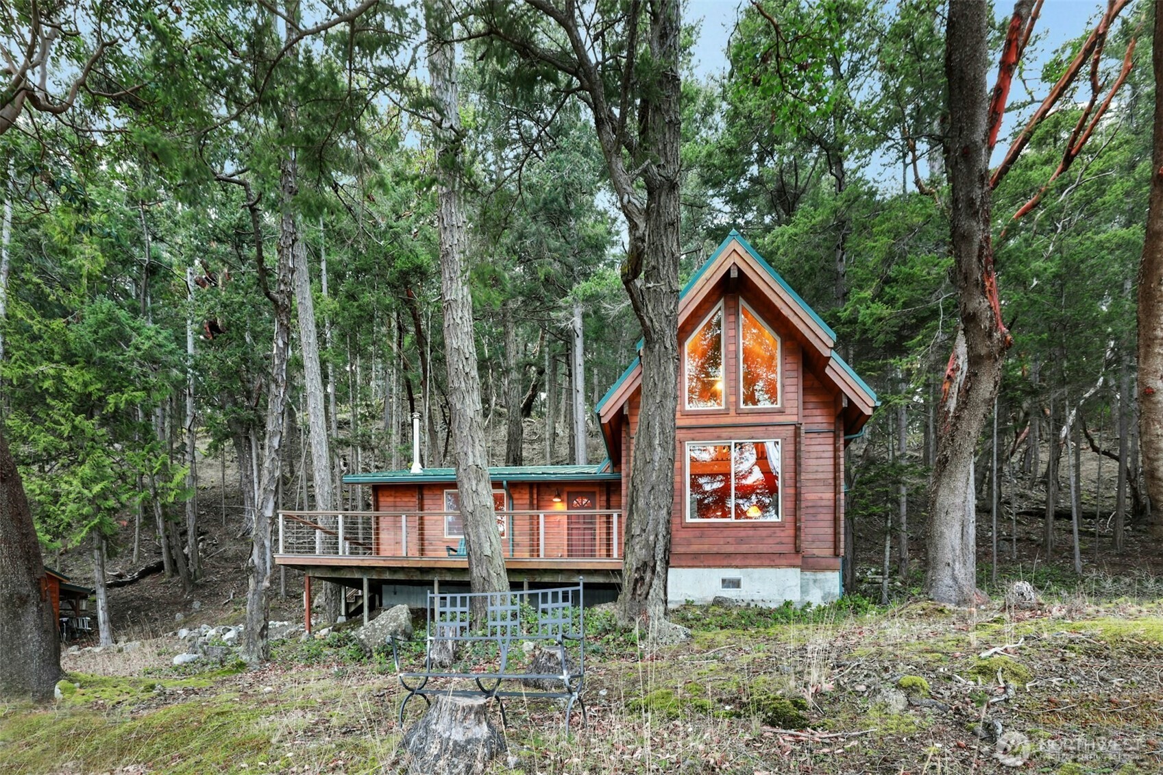 a front view of a house with balcony and trees