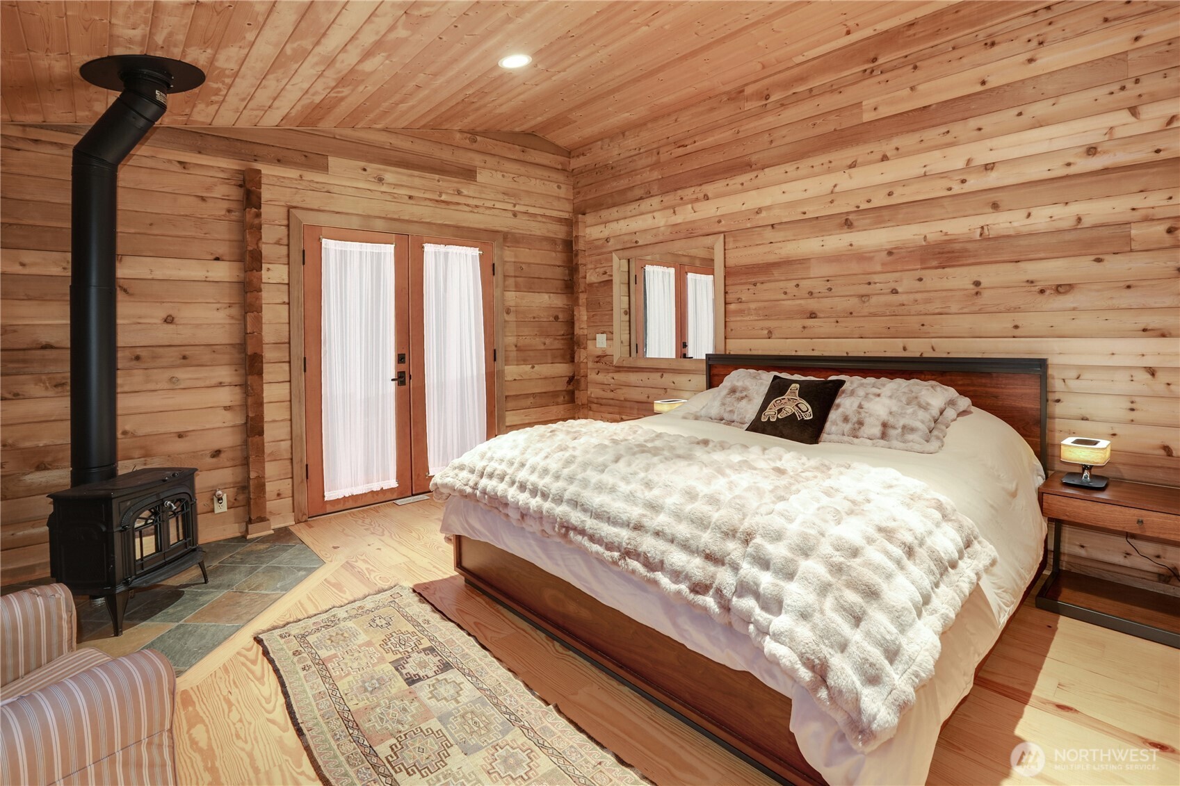 5 Smugglers Cove Road Friday Harbor, WA 98250 - Photo 12 of 36 a bedroom with a bed and wooden floor