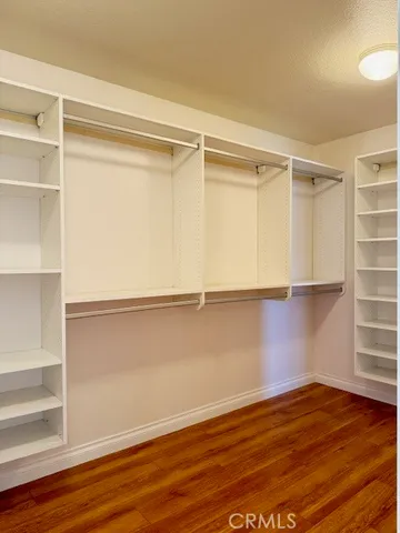 a view of a room with wooden floor and small cabinets