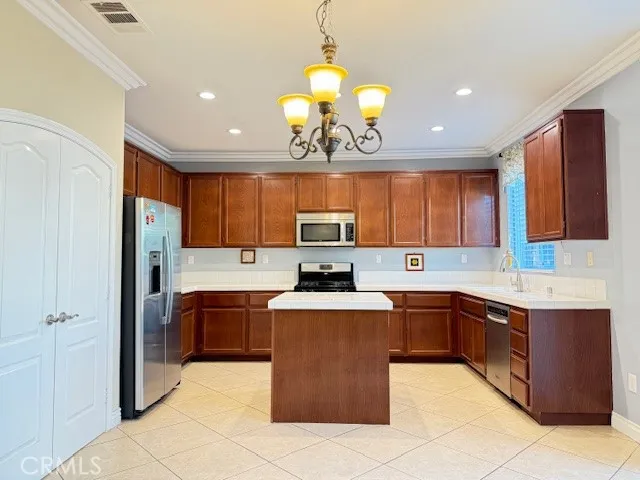 a large kitchen with stainless steel appliances granite countertop a sink and cabinets