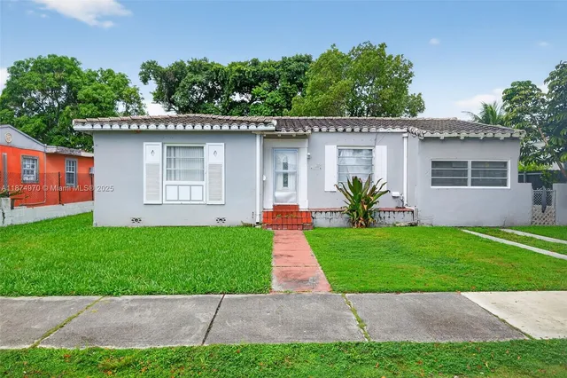 a front view of a house with a yard and a garage