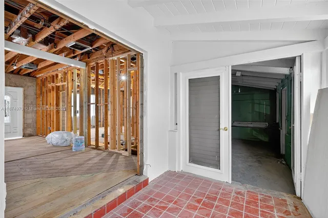 a view of an empty room and wooden floor