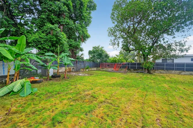 a view of yard with green space and trampoline