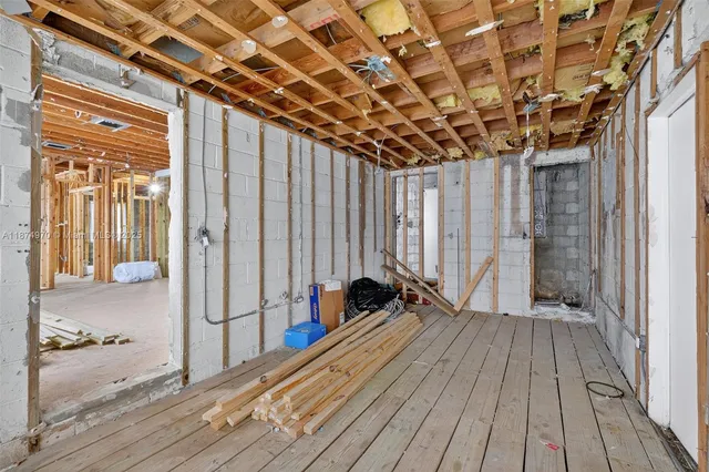 a view of a room with wooden floor and iron stairs