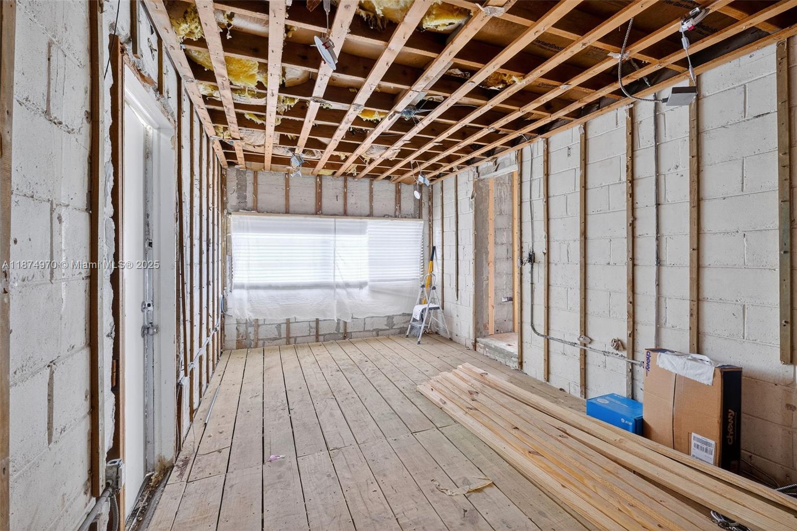 2850 Northwest 4th Street Miami, FL 33125 - Photo 10 of 17 a view of an empty room with wooden floor and a window
