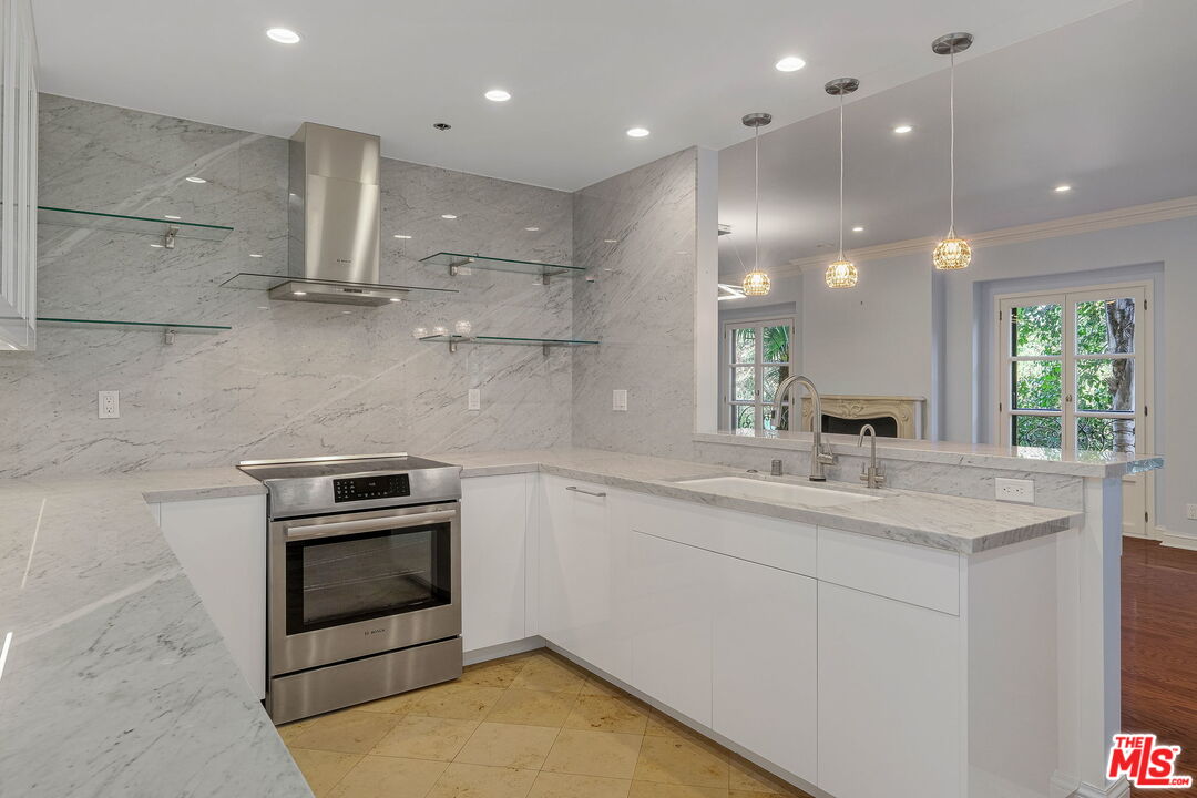 425 North Maple Drive, Unit 304 Beverly Hills, CA 90210 - Photo 13 of 26 a kitchen with a sink stainless steel appliances and cabinets