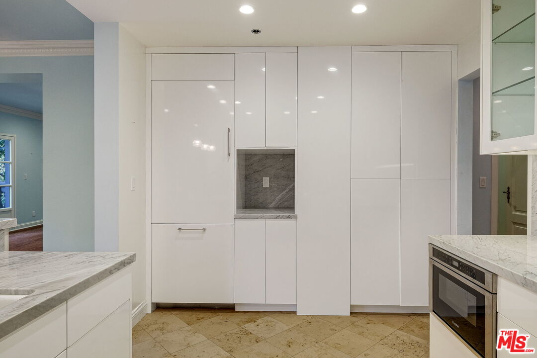 425 North Maple Drive, Unit 304 Beverly Hills, CA 90210 - Photo 14 of 26 a view of kitchen with granite countertop cabinets and sink