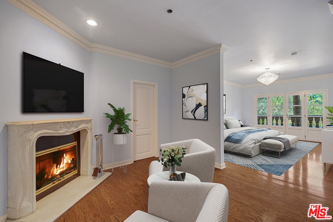 425 North Maple Drive, Unit 304 Beverly Hills, CA 90210 - Photo 15 of 26 a living room with furniture a flat screen tv and a fireplace