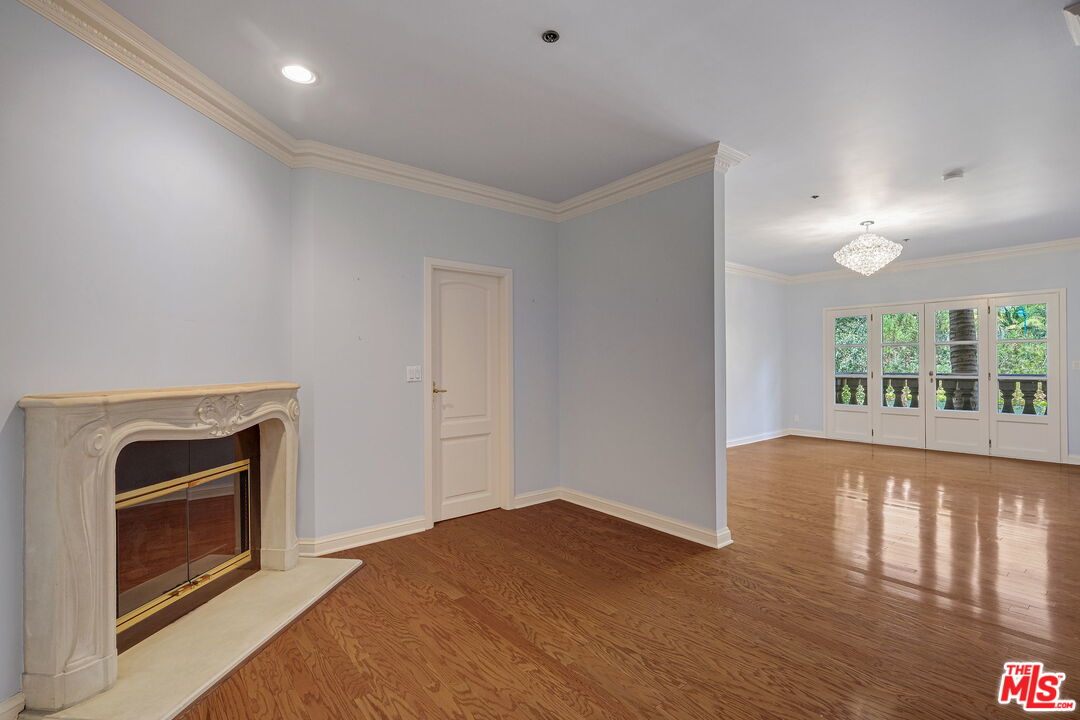 425 North Maple Drive, Unit 304 Beverly Hills, CA 90210 - Photo 16 of 26 a view of an empty room with wooden floor and a window