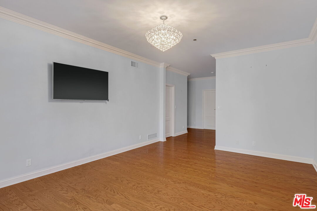 425 North Maple Drive, Unit 304 Beverly Hills, CA 90210 - Photo 18 of 26 a view of an empty room with a window and a ceiling fan