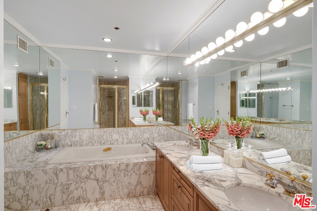 425 North Maple Drive, Unit 304 Beverly Hills, CA 90210 - Photo 19 of 26 a large bathroom with a large tub and double vanity