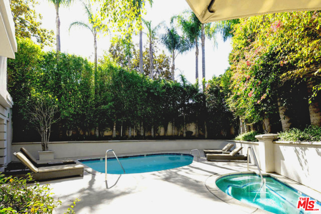425 North Maple Drive, Unit 304 Beverly Hills, CA 90210 - Photo 24 of 26 a swimming pool with outdoor seating and yard
