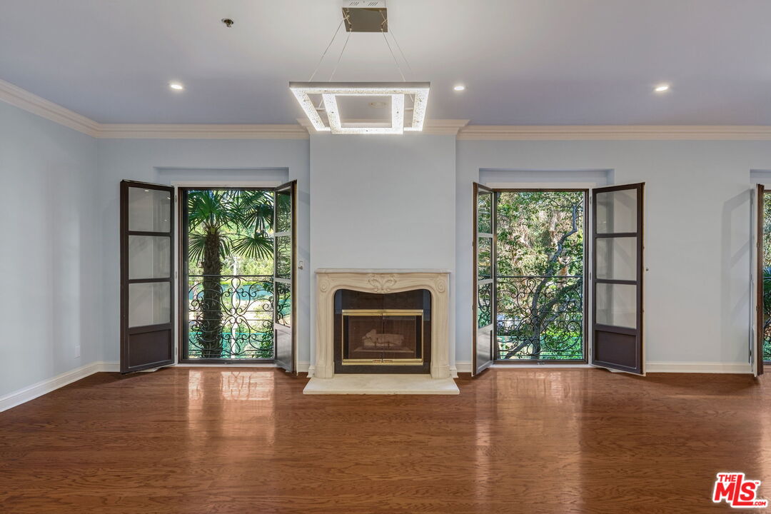 425 North Maple Drive, Unit 304 Beverly Hills, CA 90210 - Photo 6 of 26 a view of an empty room with a window and a fireplace