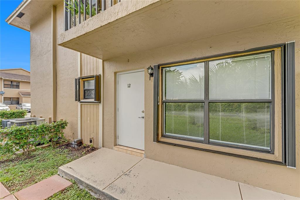 a view of backyard with large windows