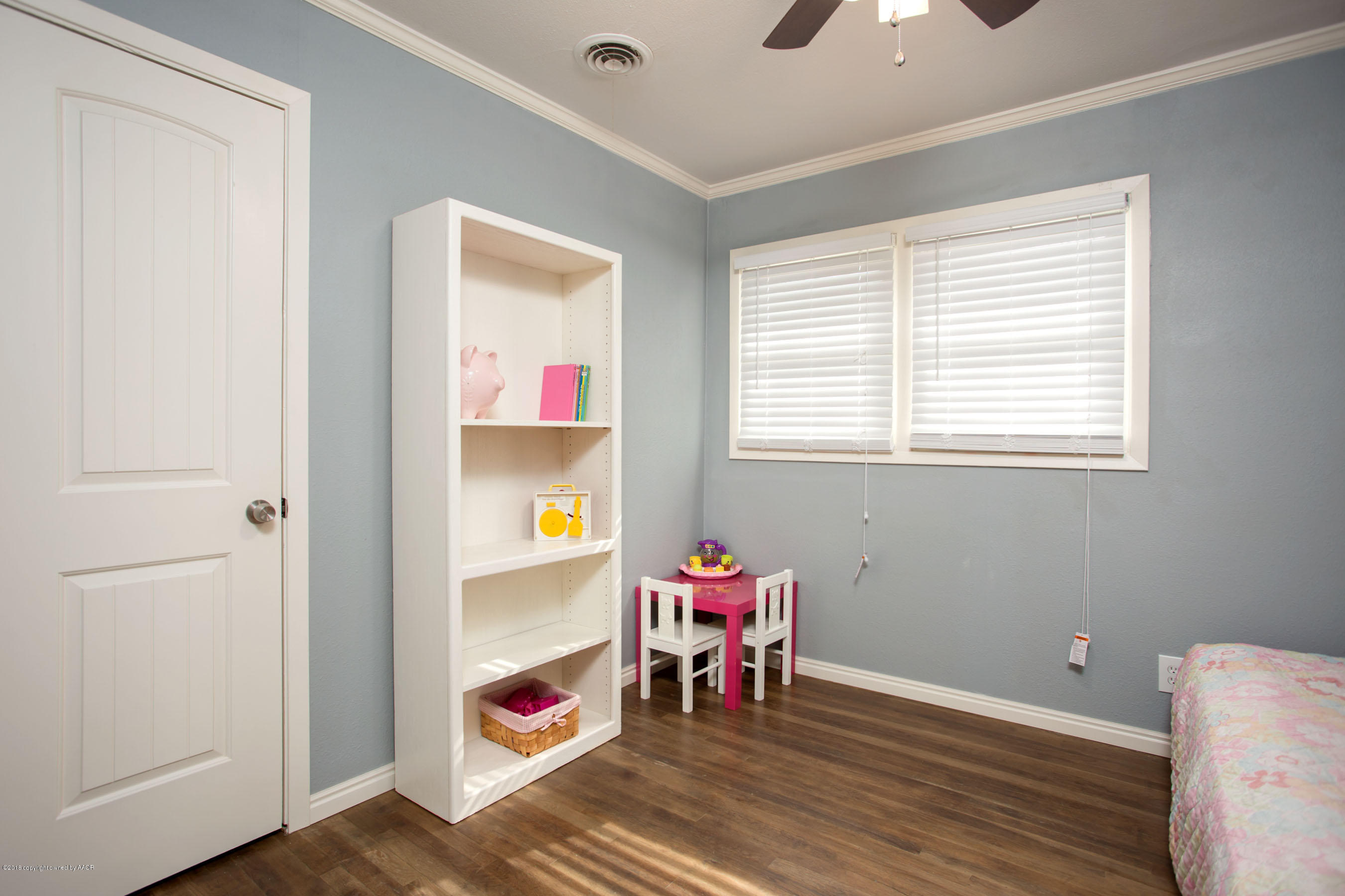 4609 South Bryan Street Amarillo, TX 79110 - Photo 16 of 26 a room that has a dresser and a chair in it