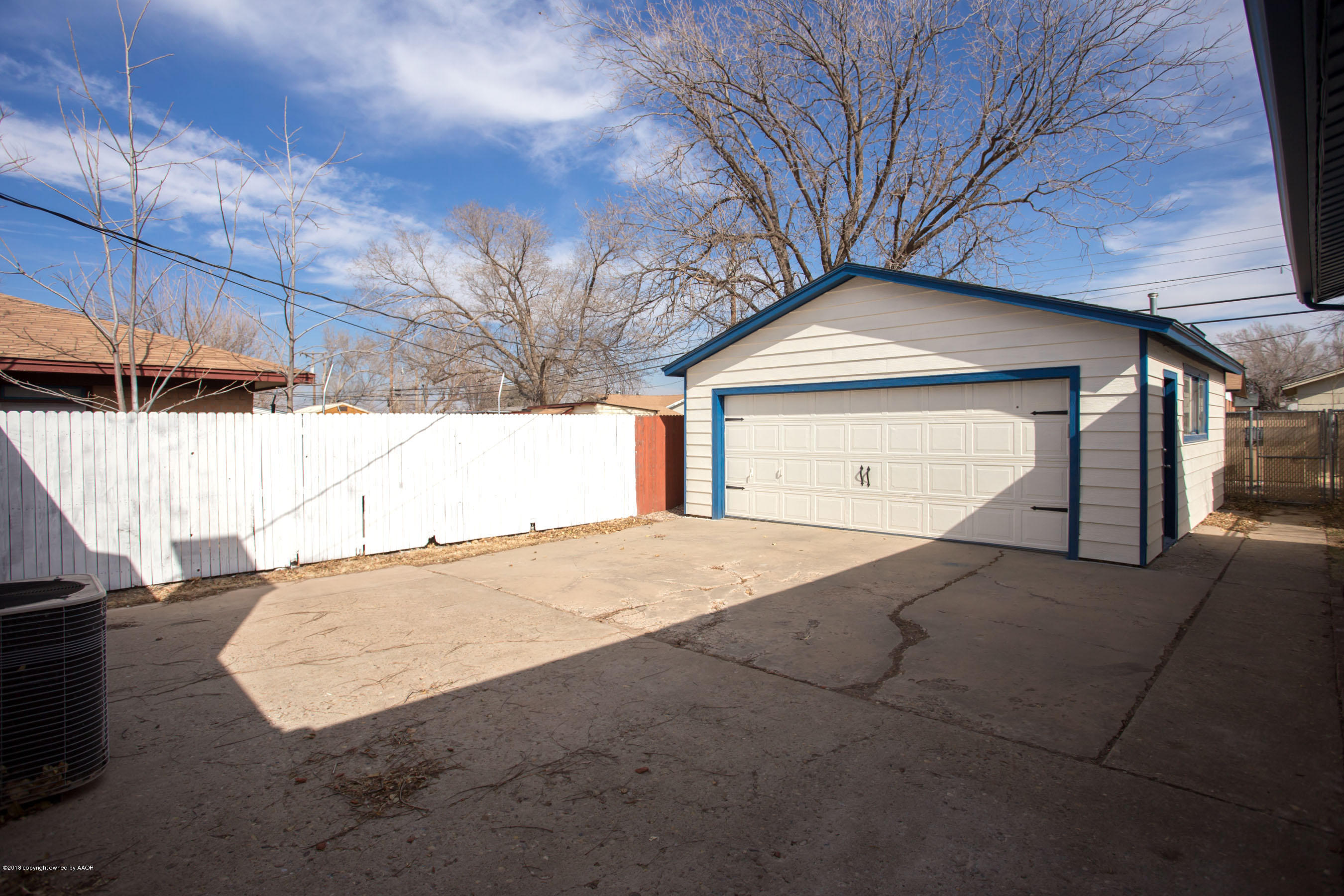 4609 South Bryan Street Amarillo, TX 79110 - Photo 25 of 26 a front view of a house with a yard and garage