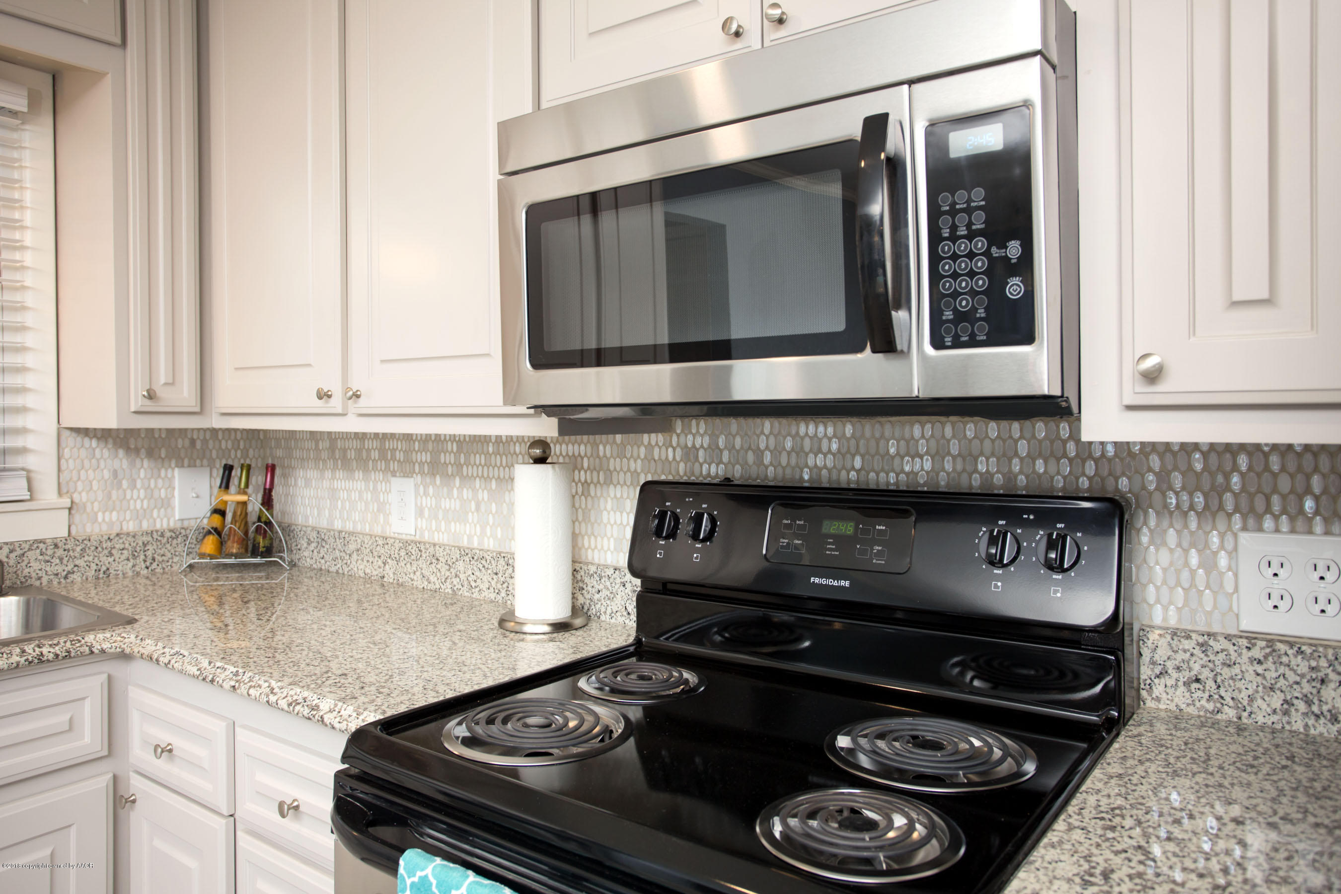 4609 South Bryan Street Amarillo, TX 79110 - Photo 9 of 26 a kitchen with a stove and a microwave