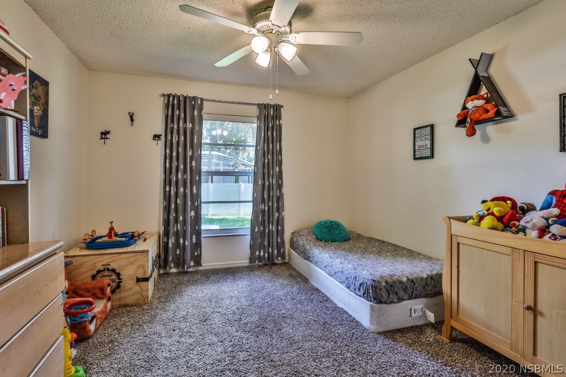 2103 Pine Tree Drive Edgewater, FL 32141 - Photo 21 of 26 a bedroom with bed and a window