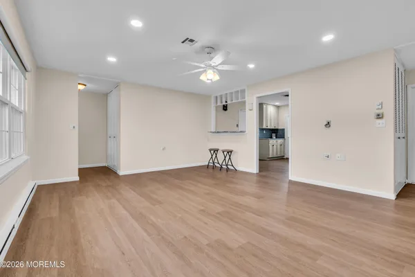 a view of empty room with wooden floor
