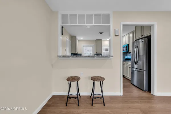 a kitchen with stainless steel appliances granite countertop a refrigerator and a stove top oven