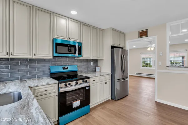 a kitchen with wooden cabinets and stainless steel appliances