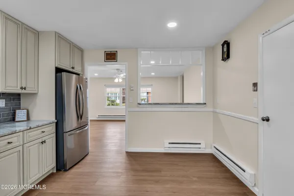 a kitchen with a refrigerator a sink and cabinets
