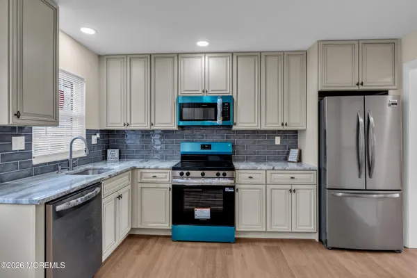 a kitchen with a stove top oven sink and refrigerator