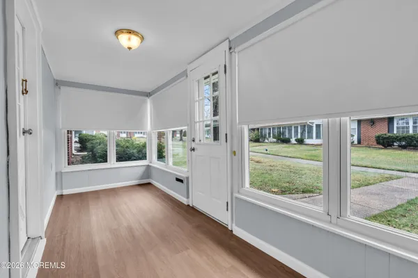 a view of room with window and wooden floor