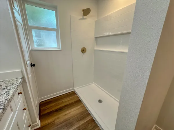a bathroom with a tub and shower