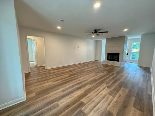 wooden floor in an empty room with a fireplace
