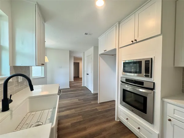 a kitchen with a stove and a microwave