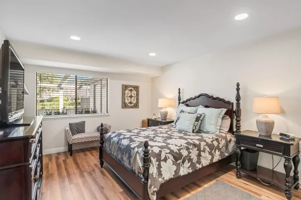 a bedroom with a bed and a flat screen tv