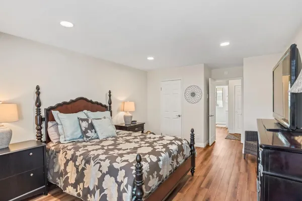 a bedroom with a bed and a flat screen tv